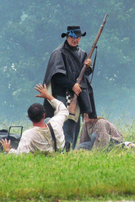 Wounded rebels plead for mercy from a Union infantryman during the Saturday battle at the 2014 event at Pittsfield, IL. 