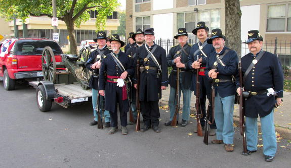Turner infantry poses behind Co. M's Filley gun on its trailer before the start of the Downtown St. Louis Veterans' Day Parade on November 5, 2016.