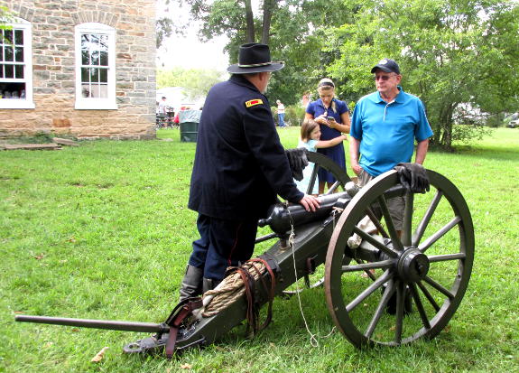 Company M's Capt. Steve Allen talks with a spectator about the Filley gun during the living history at the Harney Mansion in Sullivan, MO, on September 3, 2016.