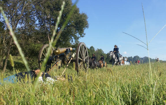 Union cavalry retreats after driving off Confederate horsemen who have killed Company M's crewmembers at the Battle of Pea Ridge reenactment in Pea Ridge, AR, September 25, 2015.